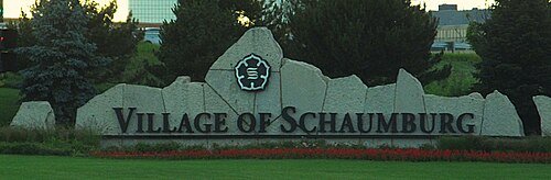 Village of Schaumburg Illinois entrance sign - stone monument welcome sign with landscaping and trees