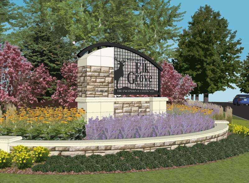 Welcome sign for Elk Grove Village, 'The Exceptional Community,' featuring a stone monument with a deer silhouette, surrounded by colorful landscaping with purple, yellow, and pink flowers, and tall green trees in the background.