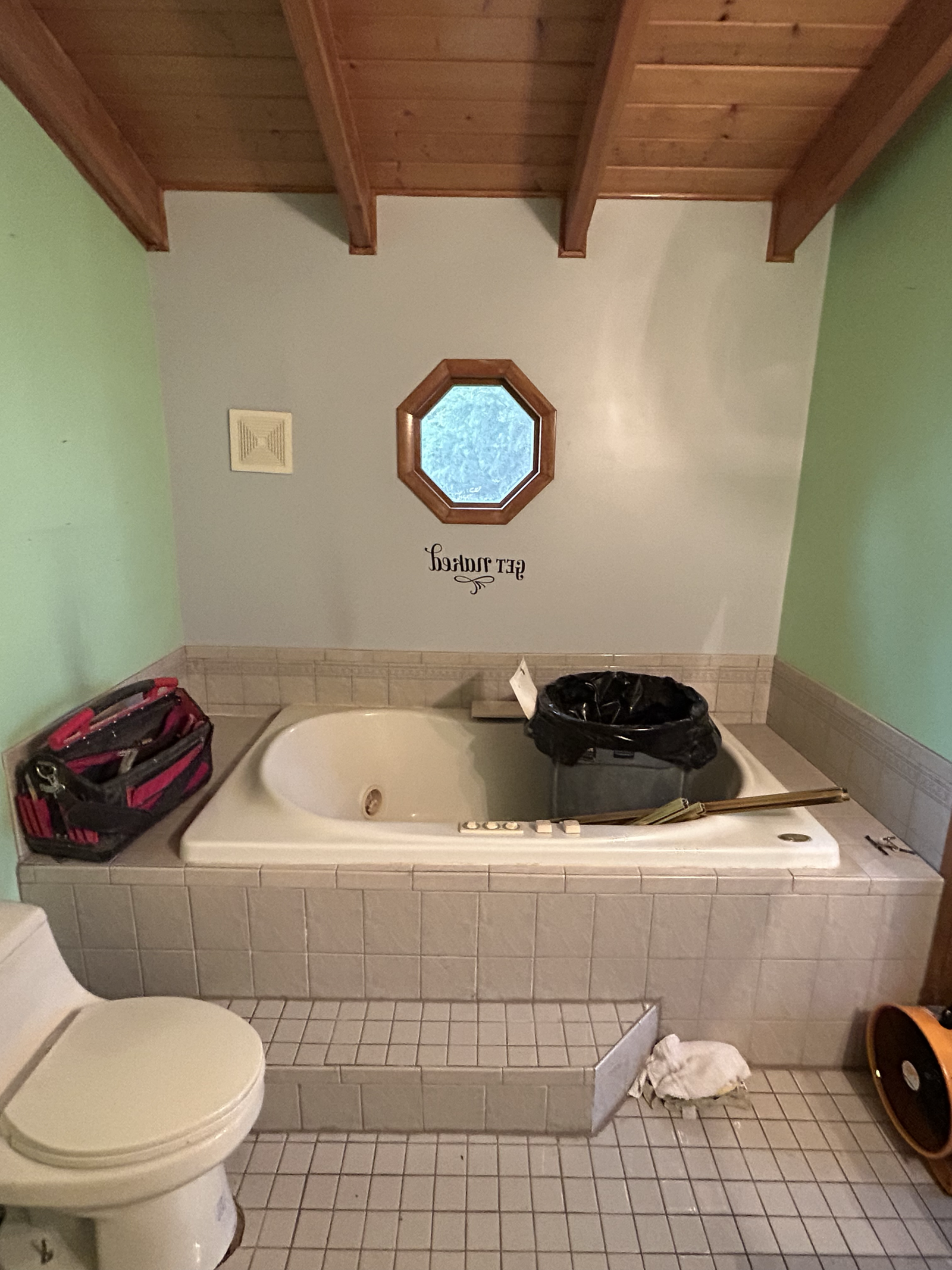 High-sided bathtub before an ADA bathroom remodel